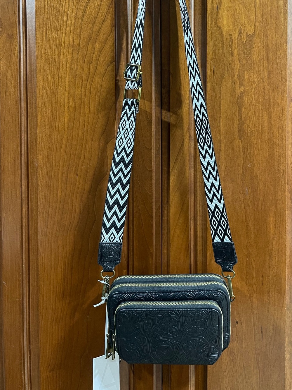 Black Embossed Leather Crossbody Bag with Patterned Strap
